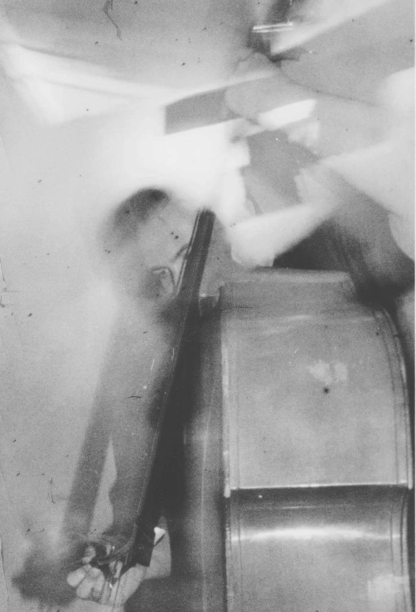 A blurred black and white photo of a person playing a double bass.